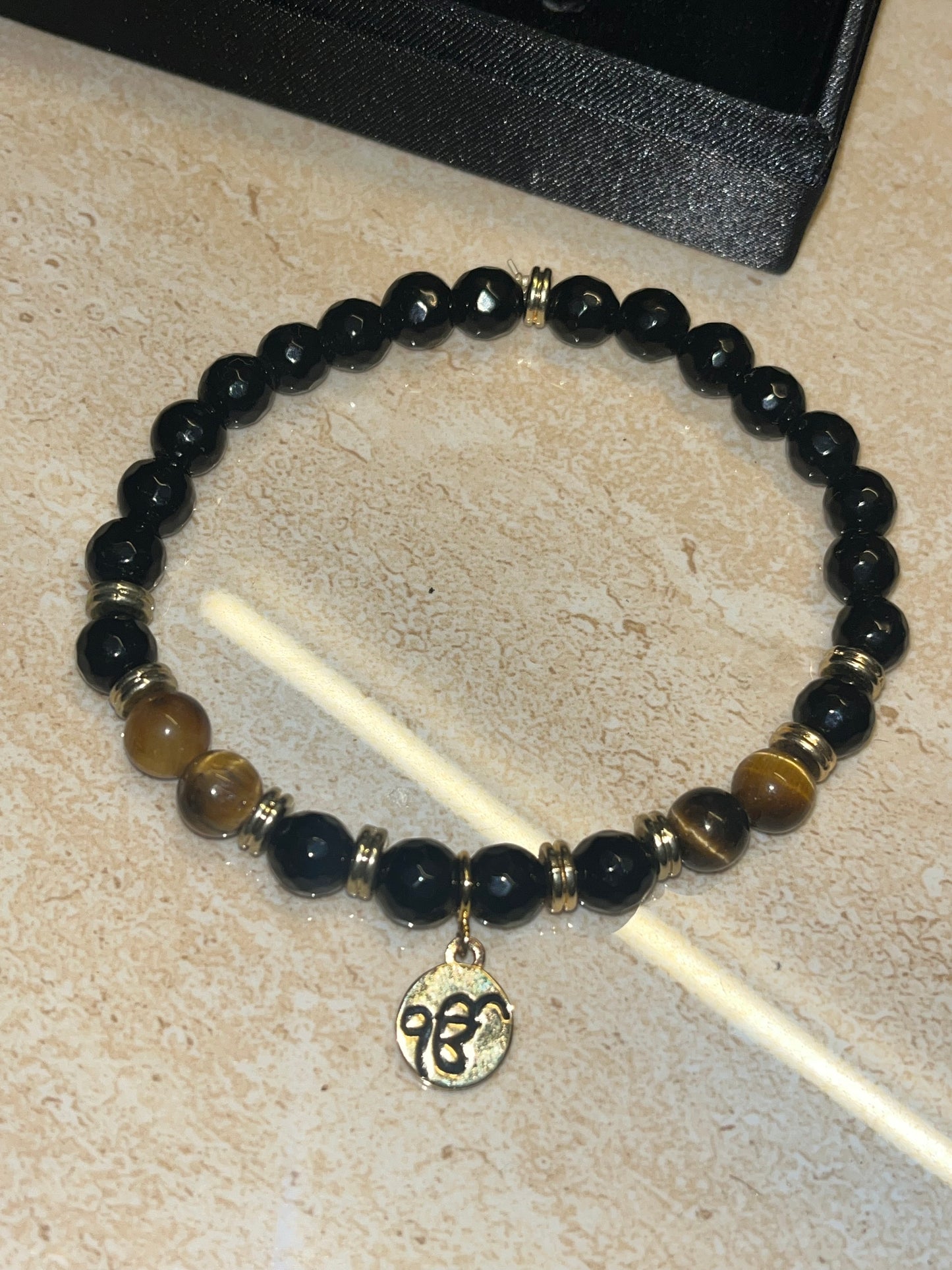 24Kt Gold Plated Ekonkar Tag Bracelet on Black Agate and Tiger Stone beads. LSO EXCLUSIVE